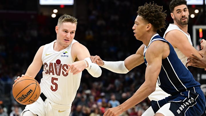 Feb 2, 2025; Cleveland, Ohio, USA; Cleveland Cavaliers guard Sam Merrill (5) drives to the basket against Dallas Mavericks forward Kessler Edwards (20) during the second half at Rocket Mortgage FieldHouse. Mandatory Credit: Ken Blaze-Imagn Images