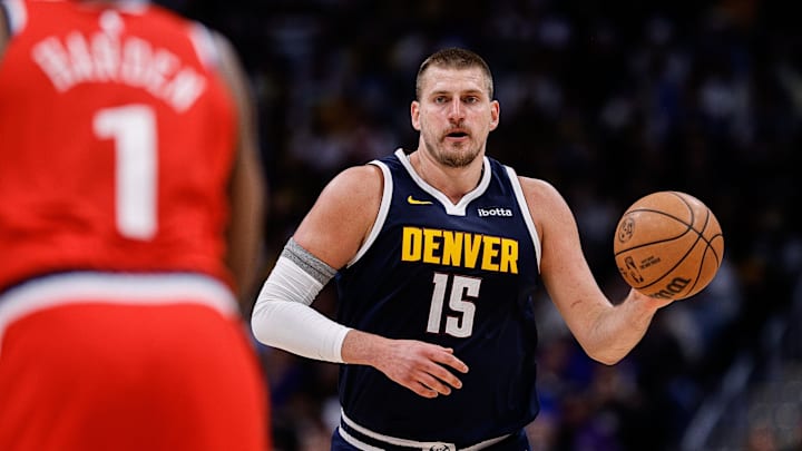 Apr 21, 2025; Denver, Colorado, USA; Denver Nuggets center Nikola Jokic (15) dribbles the ball up court against Los Angeles Clippers guard James Harden (1) in the third quarter during game two of first round for the 2025 NBA Playoffs at Ball Arena. Mandatory Credit: Isaiah J. Downing-Imagn Images