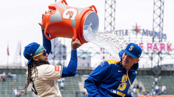 Seattle Mariners shortstop J.P. Crawford (left) douses pitcher Logan Evans with water after a game against the Miami Marlins on April 27 at T-Mobile Park.