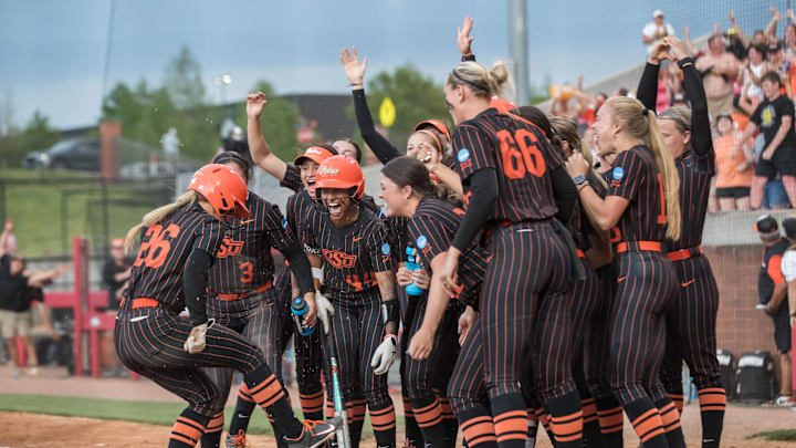 May 17, 2025; Fayetteville, AR, USA;  the Oklahoma State Cowgirls players greet infielder Rosie Davis (26) after her home run during the third inning against the Indiana Hoosiers. Oklahoma State won 16-8.  Mandatory Credit: Brett Rojo-Imagn Images