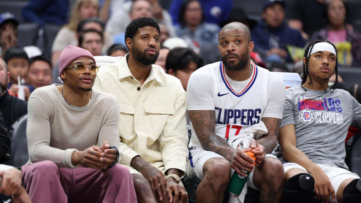 Mar 10, 2024; Los Angeles, California, USA;  Los Angeles Clippers guard Russell Westbrook (left) and forward Paul George (second from left) watch the game from the bench during the second half against the Milwaukee Bucks at Crypto.com Arena. Mandatory Credit: Kiyoshi Mio-USA TODAY Sports