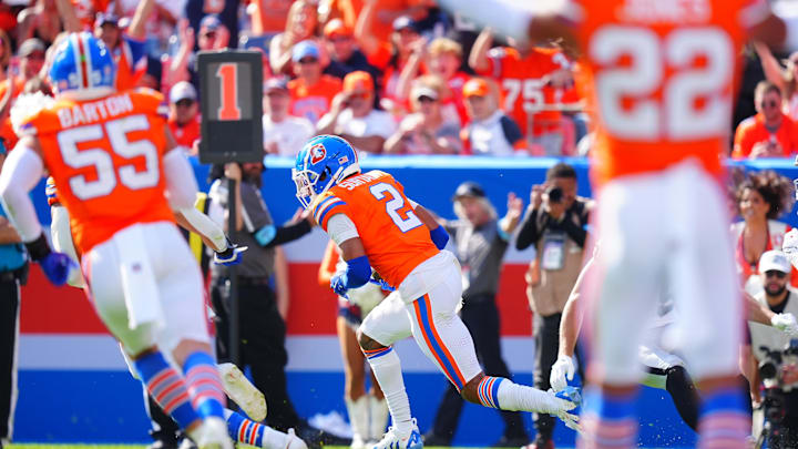 Oct 6, 2024; Denver, Colorado, USA; Denver Broncos cornerback Pat Surtain II (2) returns an interception for a touchdown against the Las Vegas Raiders in the second quarter at Empower Field at Mile High. Mandatory Credit: Ron Chenoy-Imagn Images