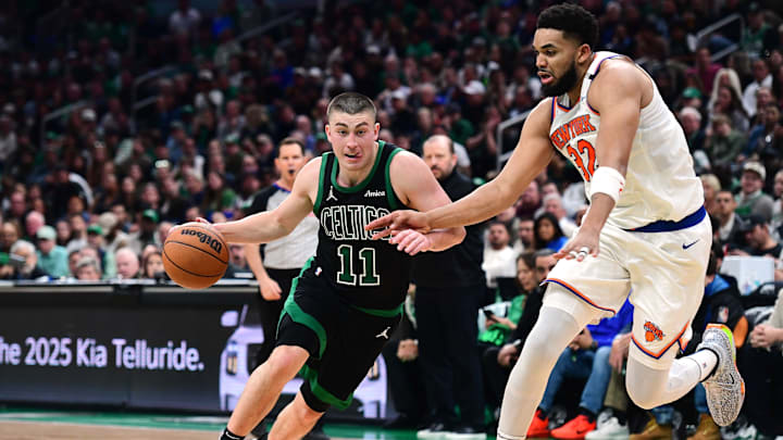 May 14, 2025; Boston, Massachusetts, USA; Boston Celtics guard Payton Pritchard (11) controls the ball while New York Knicks center Karl-Anthony Towns (32) defends in the second half during game five of the second round for the 2025 NBA Playoffs at TD Garden. Mandatory Credit: Bob DeChiara-Imagn Images