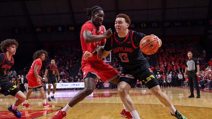 Feb 15, 2026; Piscataway, New Jersey, USA; Maryland Terrapins forward Elijah Saunders (13) goes to the basket as Rutgers Scarlet Knights forward Christopher Nwuli (11) defends during the first half at Jersey Mike's Arena. Mandatory Credit: Vincent Carchietta-Imagn Images