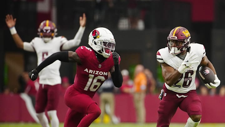 Cardinals cornerback Max Melton (16) chases down Commanders runningback Jeremy McNichols (26) during a game at State Farm Stadium in Glendale on Sept. 29, 2024.