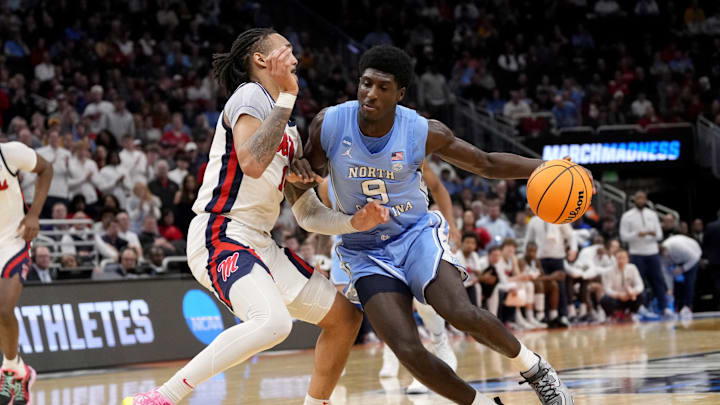 Mar 21, 2025; Milwaukee, WI, USA; North Carolina Tar Heels guard Drake Powell (9) drives against Mississippi Rebels guard Dre Davis (14) during the second half of a first round NCAA men’s tournament game at Fiserv Forum. 