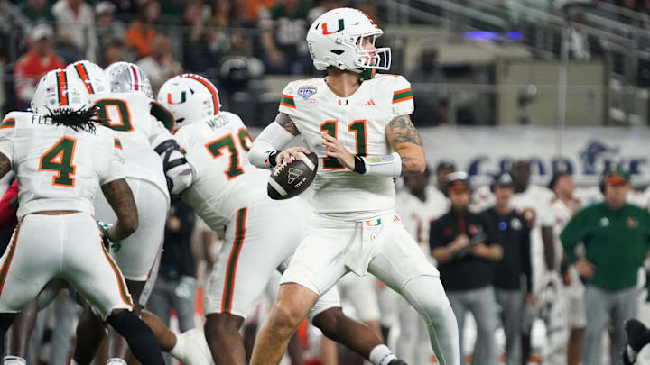 Dec 31, 2025; Arlington, TX, USA; Miami Hurricanes quarterback Carson Beck (11) looks to throw in the second quarter against the Ohio State Buckeyes during the 2025 Cotton Bowl and quarterfinal game of the College Football Playoff at AT&T Stadium. Mandatory Credit: Raymond Carlin III-Imagn Images