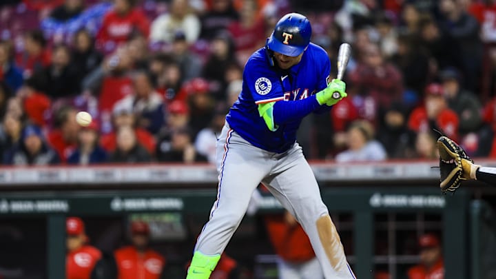 Apr 1, 2025; Cincinnati, Ohio, USA; Texas Rangers designated hitter Joc Pederson (4) gets hit by a wild pitch in the sixth inning against the Cincinnati Reds at Great American Ball Park. Mandatory Credit: Katie Stratman-Imagn Images
