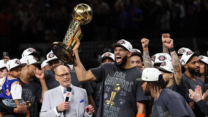 Jun 13, 2026; San Antonio, Texas, USA; New York Knicks center Karl-Anthony Towns (R) celebrates with the Larry O'Brien championship trophy 