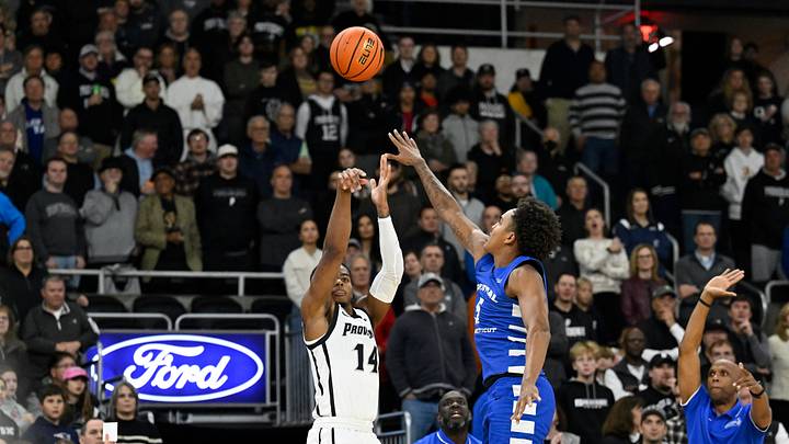 Nov 4, 2024; Providence, Rhode Island, USA; Providence Friars guard Corey Floyd Jr. (14) shoots over Central Connecticut State Blue Devils forward Darin Smith Jr. (5) at Amica Mutual Pavilion. Mandatory Credit: Eric Canha-Imagn Images Nov 4, 2024; Providence, Rhode Island, USA; Providence Friars guard Corey Floyd Jr. (14) shoots over Central Connecticut State Blue Devils forward Darin Smith Jr. (5) at Amica Mutual Pavilion. Mandatory Credit: Eric Canha-Imagn Images