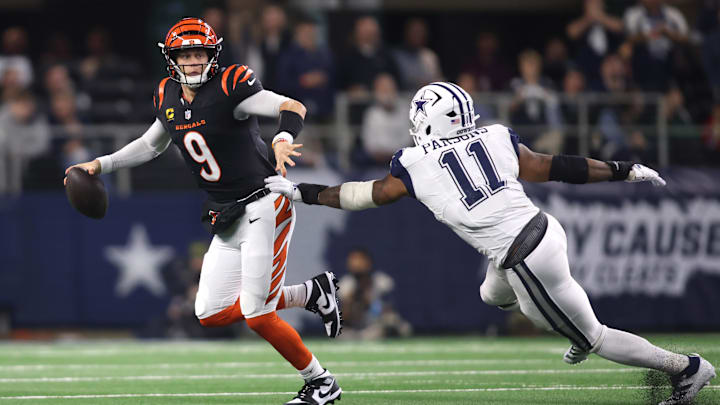 Dec 9, 2024; Arlington, Texas, USA; Cincinnati Bengals quarterback Joe Burrow (9) avoids the tackle of Dallas Cowboys linebacker Micah Parsons (11) in the second half at AT&T Stadium. Mandatory Credit: Tim Heitman-Imagn Images Dec 9, 2024; Arlington, Texas, USA; Cincinnati Bengals quarterback Joe Burrow (9) avoids the tackle of Dallas Cowboys linebacker Micah Parsons (11) in the second half at AT&T Stadium. Mandatory Credit: Tim Heitman-Imagn Images