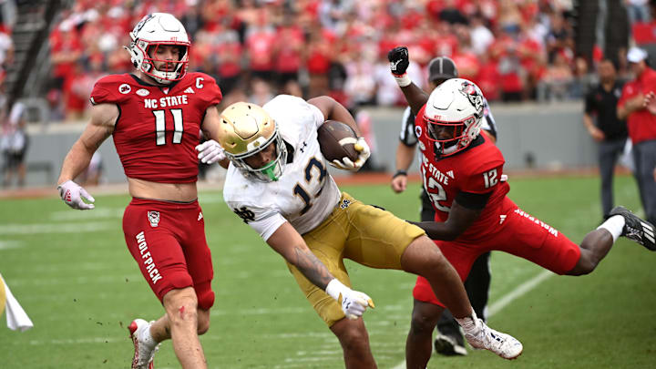 Sep 9, 2023; Raleigh, North Carolina, USA; Notre Dame Fighting Irish tight end Holden Staes (13) is knocked out of bounds by North Carolina State Wolfpack safety Devan Boykin (12) after a catch during the second half at Carter-Finley Stadium. Mandatory Credit: Rob Kinnan-Imagn Images Sep 9, 2023; Raleigh, North Carolina, USA; Notre Dame Fighting Irish tight end Holden Staes (13) is knocked out of bounds by North Carolina State Wolfpack safety Devan Boykin (12) after a catch during the second half at Carter-Finley Stadium. Mandatory Credit: Rob Kinnan-Imagn Images
