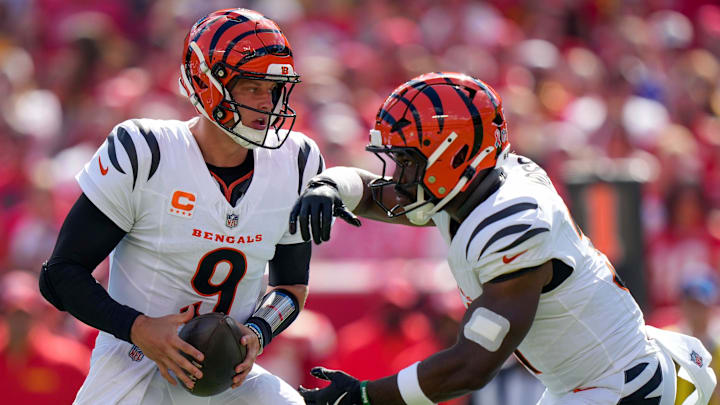 Cincinnati Bengals quarterback Joe Burrow (9) fakes a hand off to Cincinnati Bengals running back Zack Moss (31) in the first quarter of the NFL Week 2 game between the Kansas City Chiefs and the Cincinnati Bengals at Arrowhead Stadium in Kansas City on Sunday, Sept. 15, 2024. The Bengals led 16-10 at halftime.