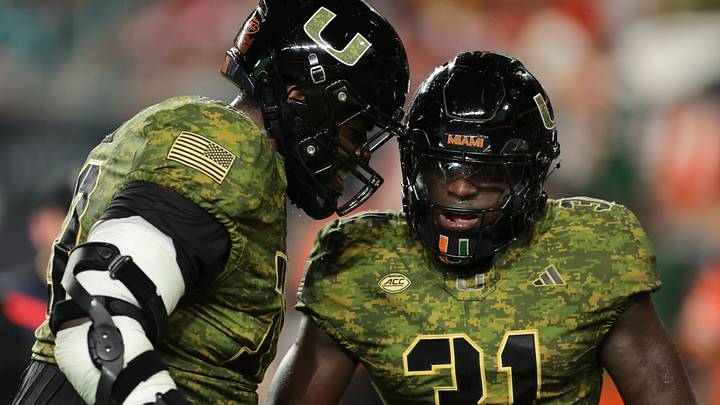 Oct 25, 2025; Miami Gardens, Florida, USA; Miami Hurricanes linebacker Wesley Bissainthe (31) celebrates with offensive lineman Markel Bell (70) after intercepting a pass against the Stanford Cardinal during the third quarter at Hard Rock Stadium. Mandatory Credit: Sam Navarro-Imagn Images