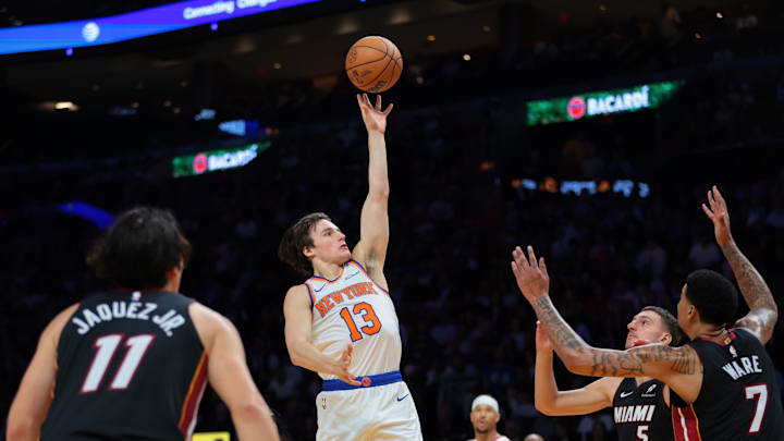 Oct 26, 2025; Miami, Florida, USA; New York Knicks guard Tyler Kolek (13) shoots the basketball over Miami Heat center Kel'el Ware (7) and forward Nikola Jovic (5) during the third quarter at Kaseya Center. Mandatory Credit: Sam Navarro-Imagn Images