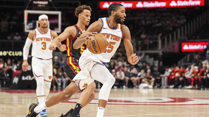 Apr 5, 2025; Atlanta, Georgia, USA; New York Knicks forward Mikal Bridges (25) dribbles past Atlanta Hawks guard Dyson Daniels (5) during the first half at State Farm Arena. Mandatory Credit: Dale Zanine-Imagn Images