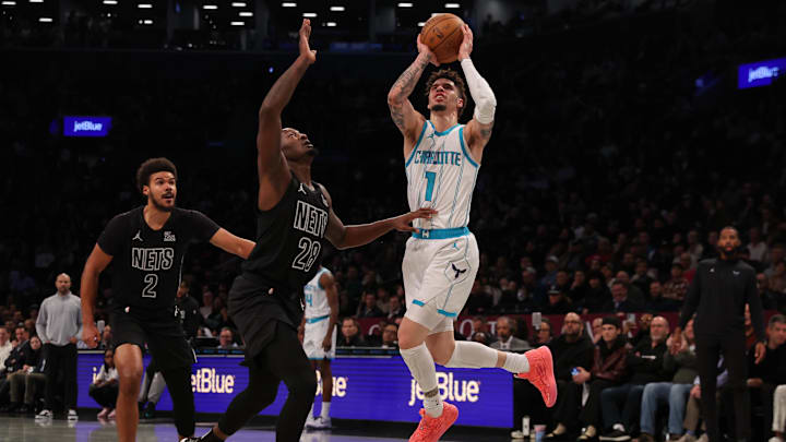 Nov 19, 2024; Brooklyn, New York, USA; Charlotte Hornets guard LaMelo Ball (1) takes a shot against Brooklyn Nets forwards Dorian Finney-Smith (28) and Cameron Johnson (2) during the first quarter at Barclays Center. Mandatory Credit: Brad Penner-Imagn Images Nov 19, 2024; Brooklyn, New York, USA; Charlotte Hornets guard LaMelo Ball (1) takes a shot against Brooklyn Nets forwards Dorian Finney-Smith (28) and Cameron Johnson (2) during the first quarter at Barclays Center. Mandatory Credit: Brad Penner-Imagn Images