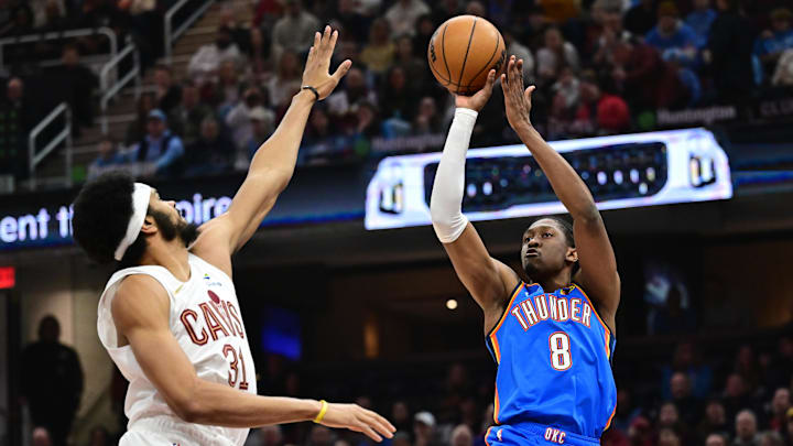 Jan 8, 2025; Cleveland, Ohio, USA; Oklahoma City Thunder forward Jalen Williams (8) shoots over the defense of  Cleveland Cavaliers center Jarrett Allen (31) during the first quarter at Rocket Mortgage FieldHouse. Mandatory Credit: Ken Blaze-Imagn Images