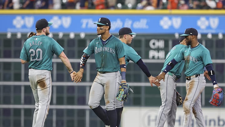 Seattle Mariners center fielder Julio Rodriguez (44) celebrates with first baseman Luke Raley (20) after the game against the Houston Astros at Minute Maid Park in 2024.