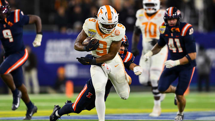 Dec 30, 2025; Nashville, TN, USA;  Illinois Fighting Illini defensive back Tyson Rooks (19) tackles Tennessee Volunteers running back Star Thomas (9) during the second half at Nissan Stadium. Mandatory Credit: Steve Roberts-Imagn Images