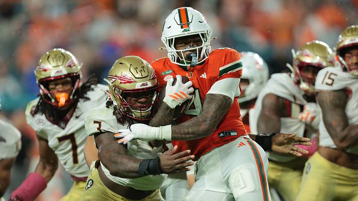 Oct 17, 2026; Miami Gardens, Florida, USA;  Miami Hurricanes running back Mark Fletcher Jr. (4) is tackled by Florida State Seminoles defensive line Mandrell Desir (3) during the second quarter at Hard Rock Stadium.  Mandatory Credit: Sam Navarro-Imagn Images