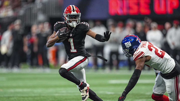 Dec 22, 2024; Atlanta, Georgia, USA; Atlanta Falcons wide receiver Darnell Mooney (1) runs against New York Giants safety Jason Pinnock (27) after a catch during the first half at Mercedes-Benz Stadium. Mandatory Credit: Dale Zanine-Imagn Images