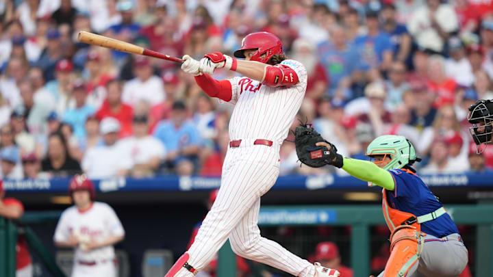 Jun 21, 2025; Philadelphia, Pennsylvania, USA; Philadelphia Phillies infielder Alec Bohm (28) hits a single against the New York Mets in the first inning at Citizens Bank Park. 