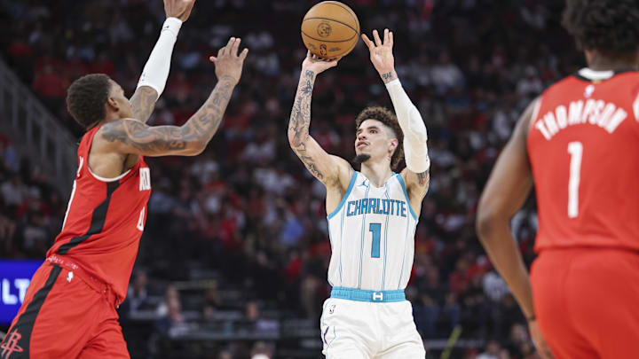 Oct 23, 2024; Houston, Texas, USA; Charlotte Hornets guard LaMelo Ball (1) shoots the ball as Houston Rockets forward Jabari Smith Jr. (10) defends during the fourth quarter at Toyota Center. Mandatory Credit: Troy Taormina-Imagn Images