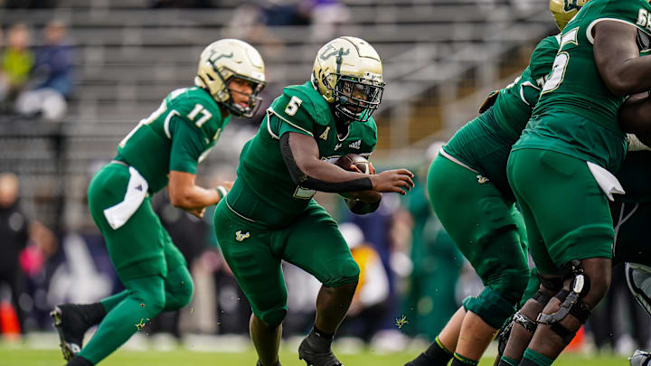 Oct 21, 2023;South Florida Bulls running back Nay'Quan Wright (5) runs through a hole created by his offensive line against the UConn Huskies in the first quarter at Rentschler Field at Pratt & Whitney Stadium. Mandatory Credit: David Butler II-USA TODAY Sports