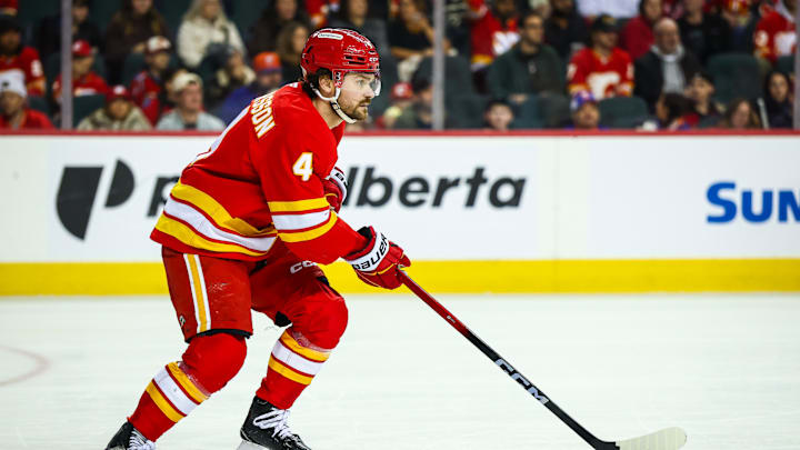 Jan 17, 2026; Calgary, Alberta, CAN; Calgary Flames defenseman Rasmus Andersson (4) skates with the puck against the New York Islanders during the third period at Scotiabank Saddledome. Mandatory Credit: Sergei Belski-Imagn Images