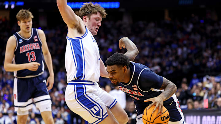 Mar 27, 2025; Newark, NJ, USA; Arizona Wildcats guard KJ Lewis (5) drives to the basket against Duke Blue Devils guard Kon Knueppel (7) during the second half during an East Regional semifinal of the 2025 NCAA tournament at Prudential Center. Mandatory Credit: Vincent Carchietta-Imagn Images