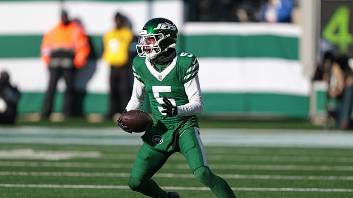 Dec 22, 2024; East Rutherford, New Jersey, USA; New York Jets wide receiver Garrett Wilson (5) gains yards after catch during the first half against the Los Angeles Rams at MetLife Stadium. Mandatory Credit: Vincent Carchietta-Imagn Images