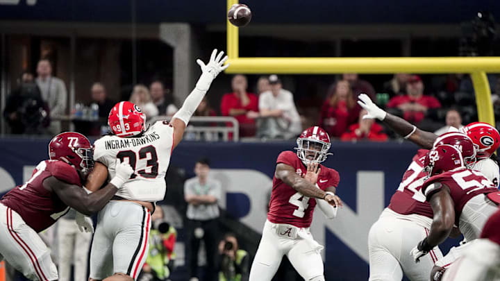 Dec 2, 2023; Atlanta, GA, USA;  Alabama Crimson Tide quarterback Jalen Milroe (4) throws against the Georgia Bulldogs during the SEC Championship at Mercedes-Benz Stadium. Mandatory Credit: Gary Cosby Jr.-Imagn Images