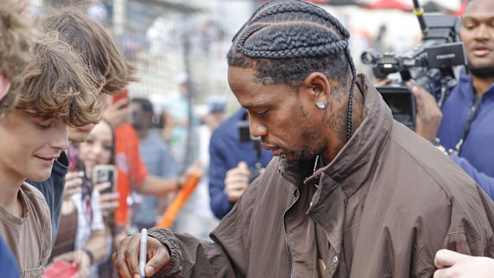 Feb 22, 2025; West Palm Beach, Florida, USA;Rap artist Travis Scott signs autographs 