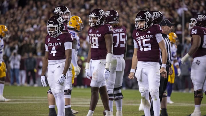 Nov 26, 2022; College Station, Texas, USA; Texas A&M Aggies quarterback Conner Weigman (15) and running back Amari Daniels (4) and tight end Donovan Green (18) in action during the game between the Texas A&M Aggies and the LSU Tigers at Kyle Field. Mandatory Credit: Jerome Miron-Imagn Images