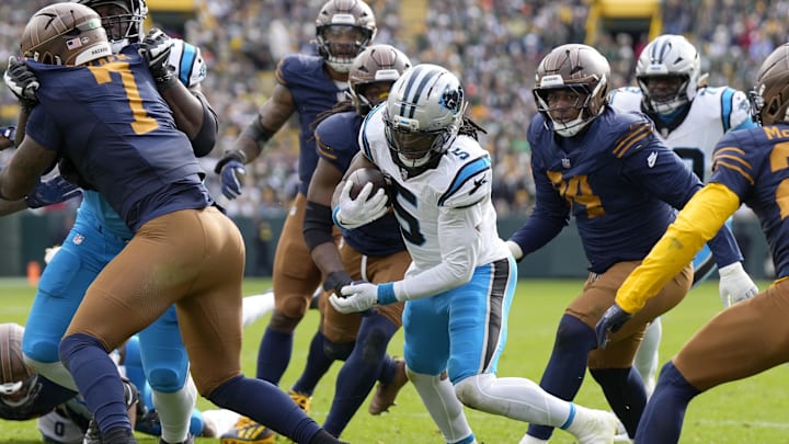 Nov 2, 2025; Green Bay, Wisconsin, USA; Carolina Panthers running back Rico Dowdle (5) scores a touchdown during the first half against the Green Bay Packers at Lambeau Field. Mandatory Credit: Jeff Hanisch-Imagn Images