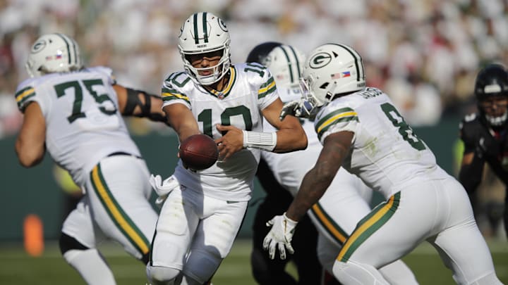Green Bay Packers quarterback Jordan Love (10) hands off the ball to running back Josh Jacobs (8) against the Houston Texans. Green Bay Packers quarterback Jordan Love (10) hands off the ball to running back Josh Jacobs (8) against the Houston Texans.