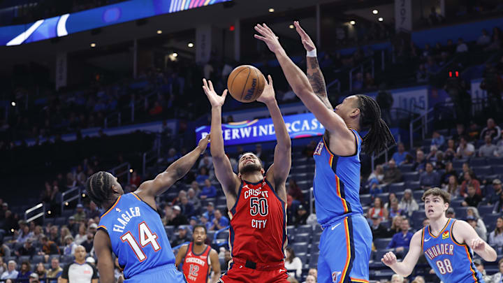 Feb 10, 2025; Oklahoma City, Oklahoma, USA; New Orleans Pelicans forward Jeremiah Robinson-Earl (50) loose the ball on a drive between Oklahoma City Thunder forward Adam Flagler (14) and forward Jaylin Williams (6) during the second half at Paycom Center. Mandatory Credit: Alonzo Adams-Imagn Images Feb 10, 2025; Oklahoma City, Oklahoma, USA; New Orleans Pelicans forward Jeremiah Robinson-Earl (50) loose the ball on a drive between Oklahoma City Thunder forward Adam Flagler (14) and forward Jaylin Williams (6) during the second half at Paycom Center. Mandatory Credit: Alonzo Adams-Imagn Images