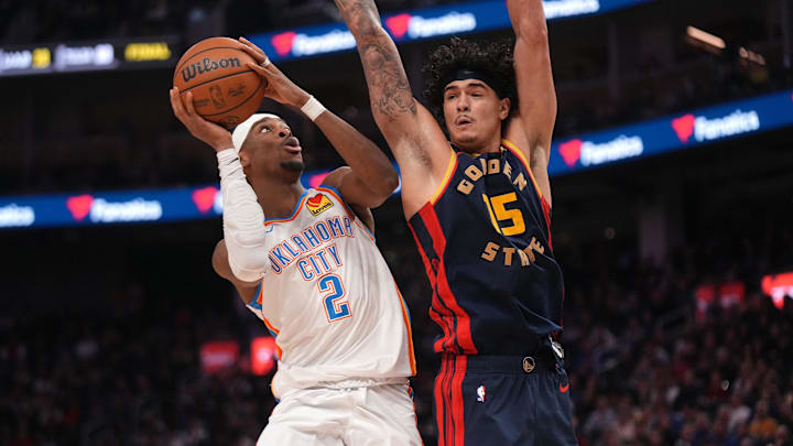 Oklahoma City Thunder guard Shai Gilgeous-Alexander goes up for a shot against Golden State Warriors forward Gui Santos.