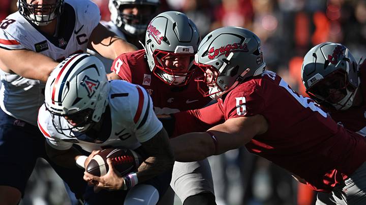 Arizona Wildcats quarterback Noah Fifita (1) is sacked by Washington State Cougars defensive end Linus Zunk (6) during the first half at Gesa Field at Martin Stadium. Arizona Wildcats quarterback Noah Fifita (1) is sacked by Washington State Cougars defensive end Linus Zunk (6) during the first half at Gesa Field at Martin Stadium.