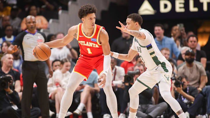 Mar 14, 2026; Atlanta, Georgia, USA; Atlanta Hawks forward Jalen Johnson (1) is defended by Milwaukee Bucks guard Ryan Rollins (13) in the second quarter at State Farm Arena. Mandatory Credit: Brett Davis-Imagn Images