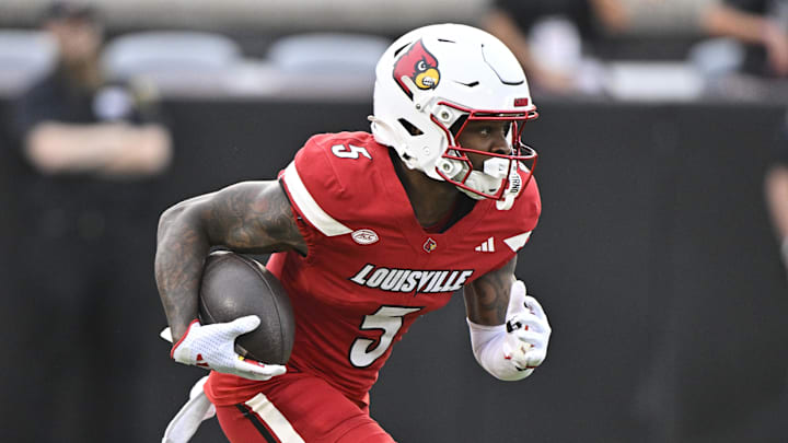 Sep 5, 2025; Louisville, Kentucky, USA;  Louisville Cardinals wide receiver Caullin Lacy (5) runs the ball against the James Madison Dukes during the first half at L&N Federal Credit Union Stadium. Louisville defeated James Madison 28-14. Mandatory Credit: Jamie Rhodes-Imagn Images