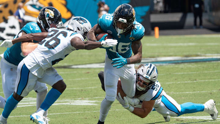 Jacksonville Jaguars running back LeQuint Allen Jr. (36) is tackled bye Carolina Panthers linebacker Christian Rozeboom (56) and Carolina Panthers cornerback Chau Smith-Wade (26) during the first quarter of an NFL football game between the Carolina Panthers at Jacksonville Jaguars at EverBank Stadium Sunday September 7, 2025. [Doug Engle/Florida Times-Union]