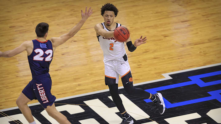 Mar 19, 2021; Indianapolis, IN, USA; Oklahoma State Cowboys guard Cade Cunningham (2) passes the ball past Liberty Flames forward Kyle Rode (22) during the first round of the 2021 NCAA Tournament at Indiana Farmers Coliseum. Mandatory Credit: Aaron Doster-Imagn Images Mar 19, 2021; Indianapolis, IN, USA; Oklahoma State Cowboys guard Cade Cunningham (2) passes the ball past Liberty Flames forward Kyle Rode (22) during the first round of the 2021 NCAA Tournament at Indiana Farmers Coliseum. Mandatory Credit: Aaron Doster-Imagn Images
