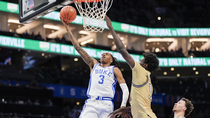 Mar 13, 2025; Charlotte, NC, USA; Duke Blue Devils guard Isaiah Evans (3) goes to the basket against Georgia Tech Yellow Jackets forward Baye Ndongo (11) during the second half at Spectrum Center.