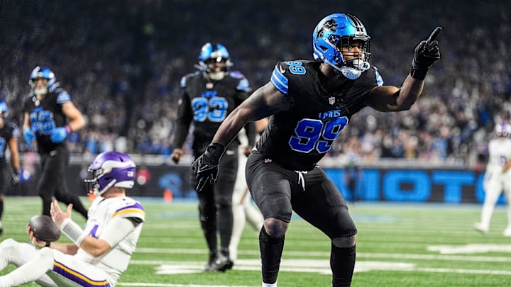 Detroit Lions defensive end Za'Darius Smith (99) celebrates a sack against Minnesota Vikings quarterback Sam Darnold (14) during the first half at Ford Field in Detroit on Sunday, Jan. 5, 2025.
