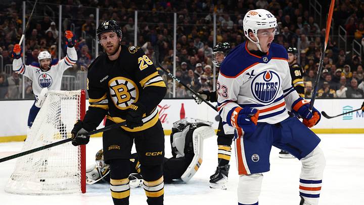 Dec 18, 2025; Boston, Massachusetts, USA; As Boston Bruins center Elias Lindholm (28) looks on, Edmonton Oilers right wing Quinn Hutson (23) celebrates his first NHL goal during the second period at TD Garden. Mandatory Credit: Winslow Townson-Imagn Images