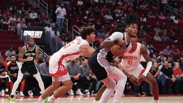 Oct 17, 2024; Houston, Texas, USA; Houston Rockets guard Reed Sheppard (15) reaches in against San Antonio Spurs guard Stephon Castle (5) in the second quarter at Toyota Center.