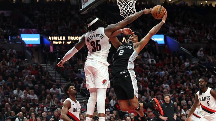 Apr 24, 2026; Portland, Oregon, USA; San Antonio Spurs guard Dylan Harper (2) goes up for a dunk over Portland Trail Blazers center Robert Williams III (35) during the second half during game three of the first round of the 2026 NBA Playoffs at Moda Center. Mandatory Credit: Jaime Valdez-Imagn Images