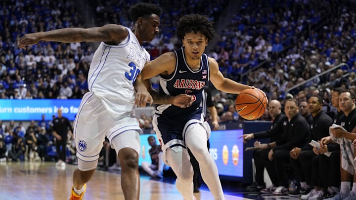 Jan 26, 2026; Provo, Utah, USA; Arizona Wildcats guard Brayden Burries (5) controls the ball while being defended by BYU Cougars forward Kennard Davis Jr. (30) during the second half at Marriott Center. Mandatory Credit: Aaron Baker-Imagn Images 